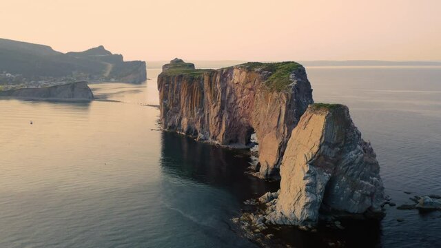 Aerial view of the Rocher Perc&eacute; in the city of Perc&eacute; in Quebec, Canada, at sunset, from drone