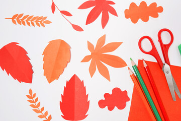 red, orange paper autumn Leaves on white background. Handmade origami.