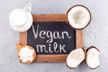 Fototapeta na wymiar Lactose free milk. Chalk board and vegan powdered coconut milk, horizontal, top view,