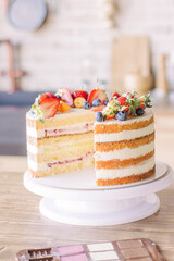 Cake, cut in half, decorated with fresh strawberries, blueberries