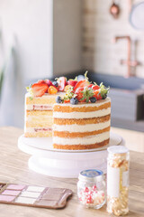 Cake, cut in half, decorated with fresh strawberries, blueberries