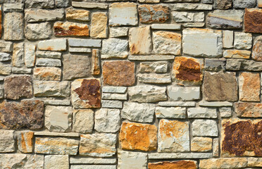 Wall of natural stone travertine or sandstone.
