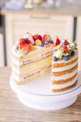 Cake, cut in half, decorated with fresh strawberries, blueberries
