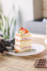 a piece of cake with strawberries on a white plate