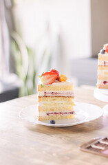 a piece of cake with strawberries on a white plate