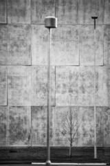 black and white photo of a concret wall with lamp post