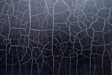 Many chaotic cracks on the surface of the textured material.