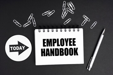 On a black background, a round plate - Today and a notebook with the inscription - Employee Handbook - obrazy, fototapety, plakaty