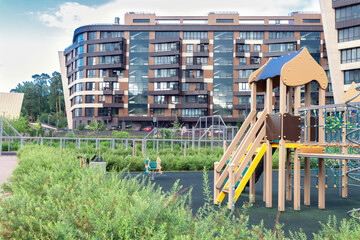 Children playground house building facade mixed-use urban multi-family residential district area settings - obrazy, fototapety, plakaty