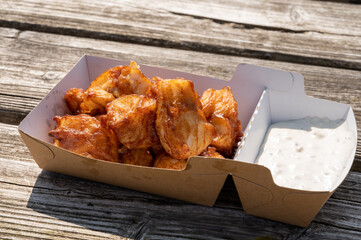 Deep fried cod fish in pieces served outdoor with tartar sauce
