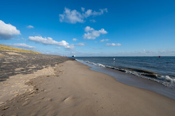 Fototapeta na wymiar View on white sandy beach, dunes and water of North sea between Vlissingen en Domburg, Zeeland, Netherlands