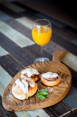 Homemade buns with cinnamon and a glass of juice