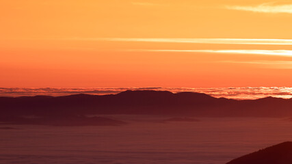 Fototapeta na wymiar Foggy dawn in the mountains, drone view.