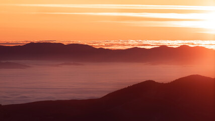 Foggy dawn in the mountains, drone view.