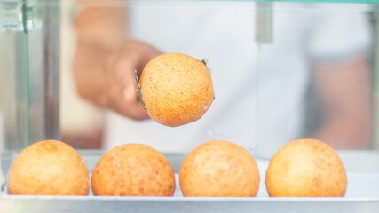 taking out the fresh fritters to eat