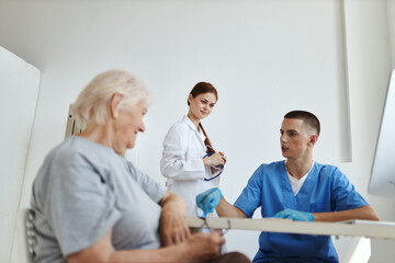 an elderly woman communicates with a nurse in the doctor's office diagnostics treatment