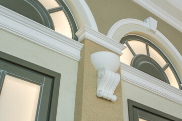 Detail of corner ceiling with intricate crown molding on column with spot light