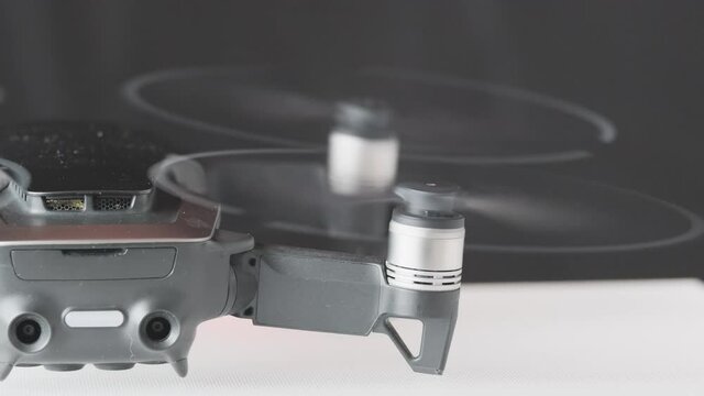Drone quadcopter engine initiation back view, futuristic gadget and electronics, professional tool for video and photo 60 fps 4K