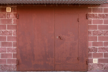 Iron double garage doors in red, locked