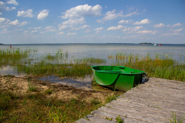 Green iron boat on the big lake