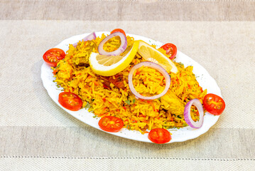 Stunning Biryani Indian Rice Recipe Served on a Tray with Cherry Tomatoes, Red Onion Rings and Lemon Garnish
