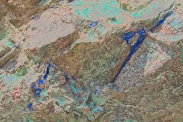 A bright blue Azurite vein runs through exposed rock near an old mining location.