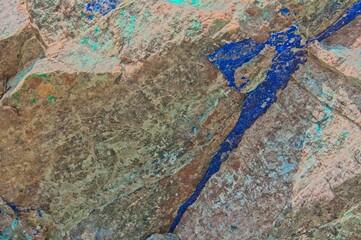 A bright blue Azurite vein runs through exposed rock near an old mining location.