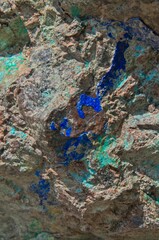 A bright blue Azurite vein runs through exposed rock near an old mining location.
