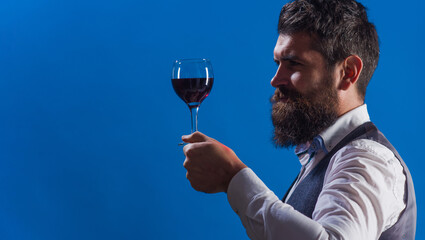 Wine tasting. Sommelier. Bearded man with wineglass. Restaurant. Degustation. Male with alcohol. Copy space for advertising.