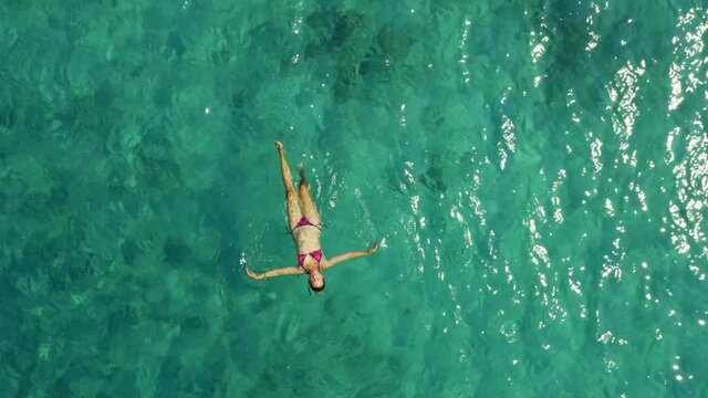 Aerial view of a girl floating on the Adriatic Sea near Korcula island, Croatia