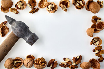 A frame made of chopped walnuts and a hammer