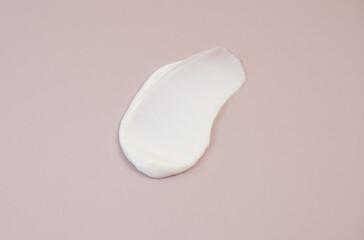 White cream texture on a pink background.