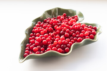 Juicy cranberries in a leaf-shaped plate