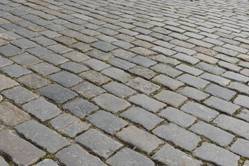 Abstract background of old cobblestone pavement close-up. Soft focus