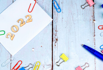 Office theme with the year 2022 on a wooden background