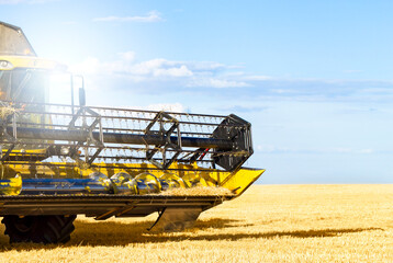 Fototapeta premium An up close view of a modern combine harvester in action.