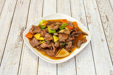 Chinese recipe for beef with sautéed vegetables. Chunks of onion, zucchini and soy sauce