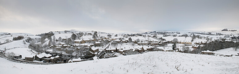 view of the North Yorkshire village of Bainbridge in winter covered in snow