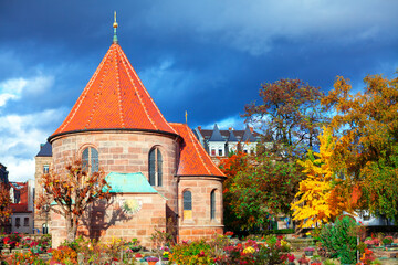 Saint Johannis Kirche in Nuremberg . Graveyard in the autumn season . Church of St. John in Bavaria Germany