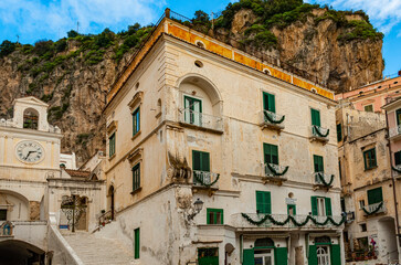 Fototapeta na wymiar Atrani, Italy - January 19, 2017: a small coastal town, just a short drive away from Amalfi, with pretty multi-colored houses nestled on steep cliffs, is one of the most picturesque and idyllic towns 