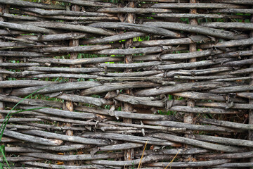 Old brushwood fence. Rustic wicker fence texture background