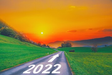 Open empty road path end and new year 2022. Upcoming 2022 goals and leaving behind 2021 year....