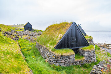 the old fishing cottages of Osvor in Bolungarvik bay in Iceland