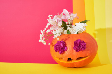 jack lantern with flowers inside on colored background, halloween concept, day of the dead background