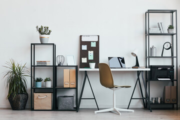 Minimal background image of modern home office workplace with laptop and accessories in black and white, copy space