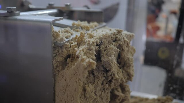 Close up view - feed extruder machine - pet mixed food production line at factory, plant, exhibition. Farming, extrusion technology, agriculture industry, animal husbandry concept