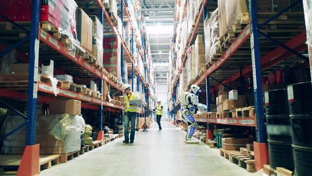 Warehouse with employees and a cyborg working together