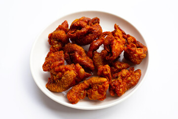 Chispy fried chicken skin in white plate on white background.