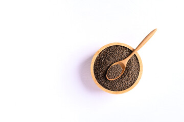 Perilla seeds in a wooden bowl with spoon on white background, Healthy herbal seed ingredients in Asian food, Top view
