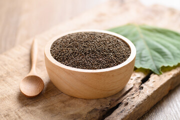 Perilla seeds in a bowl with spoon on wooden background, Healthy herbal seed ingredients in Asian food